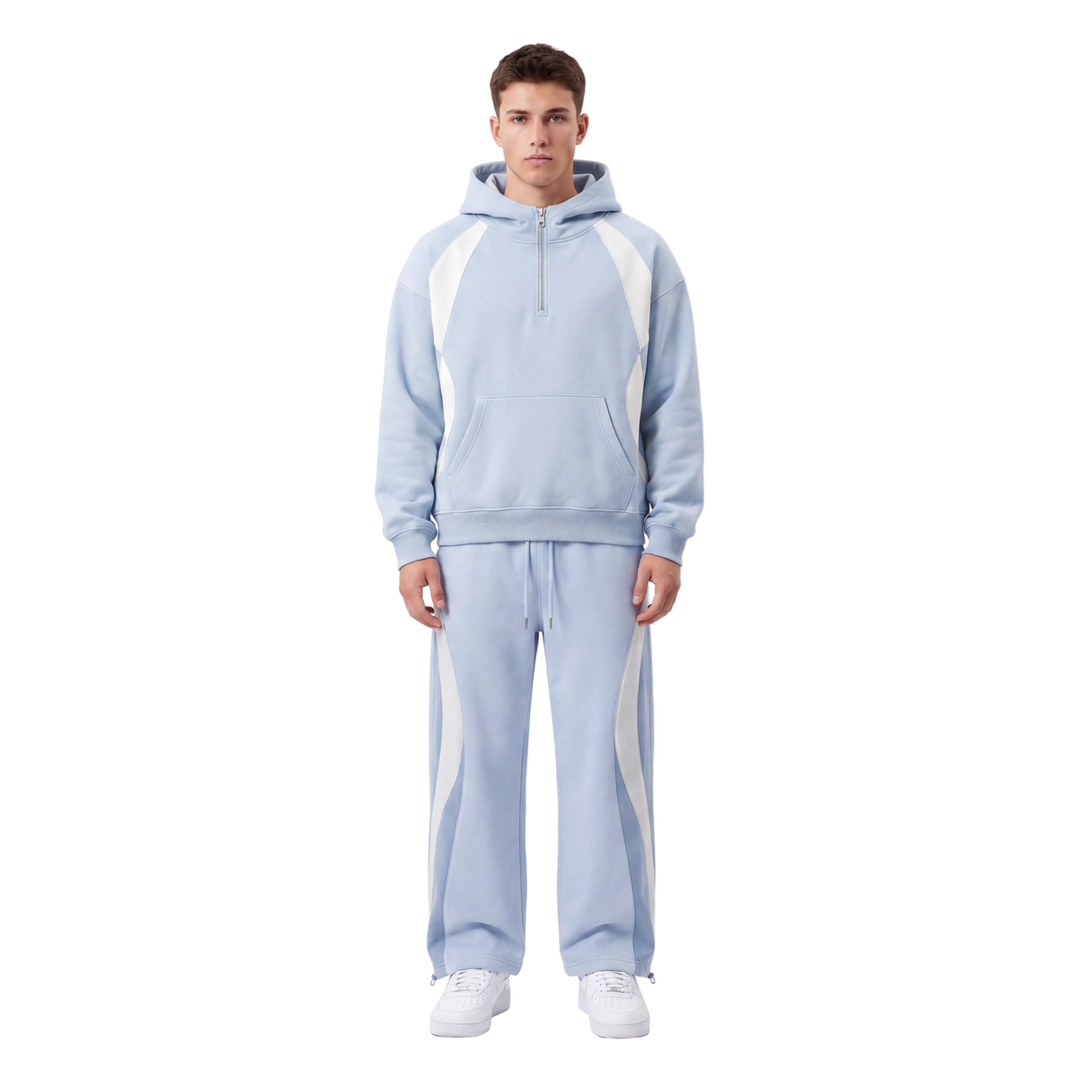 A man modeling a light blue tracksuit with white side panels, featuring a half-zip hoodie and matching sweatpants, against a plain white studio background.